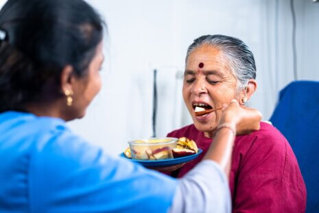 A senior receiving support for Activities of Daily Living (ADLs) to enhance independence and well-being.